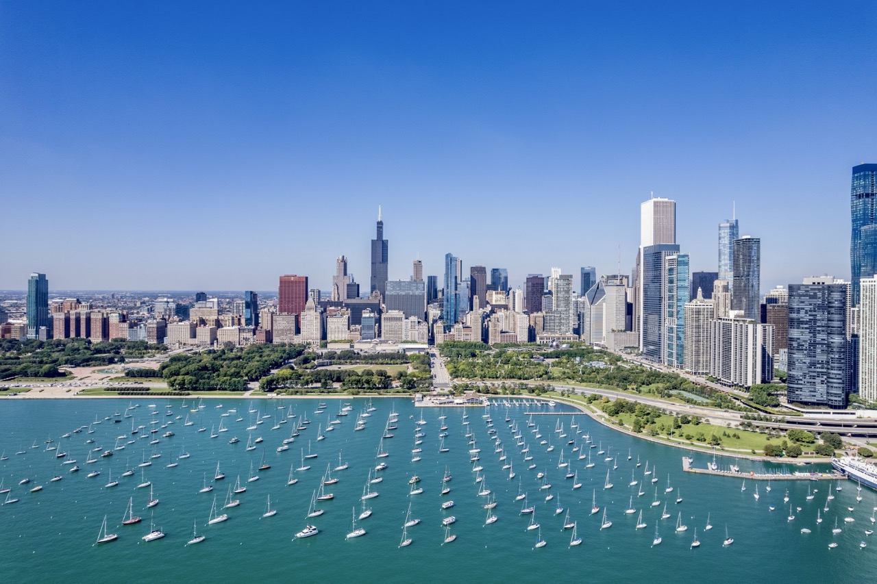 Drone view over Lake Michigan looking west toward Chicago's skyline and Willis Tower.